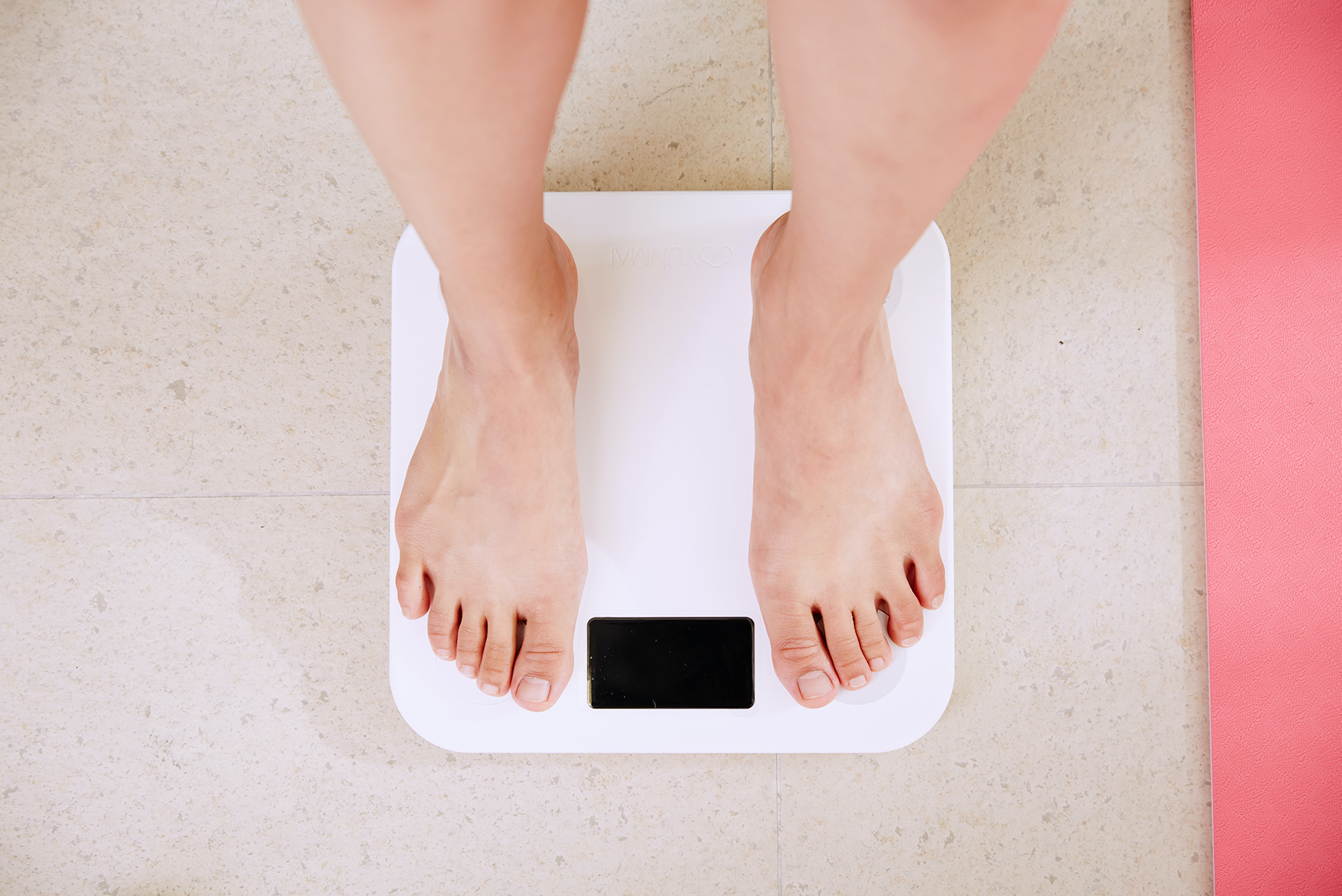 Person standing in weight scale