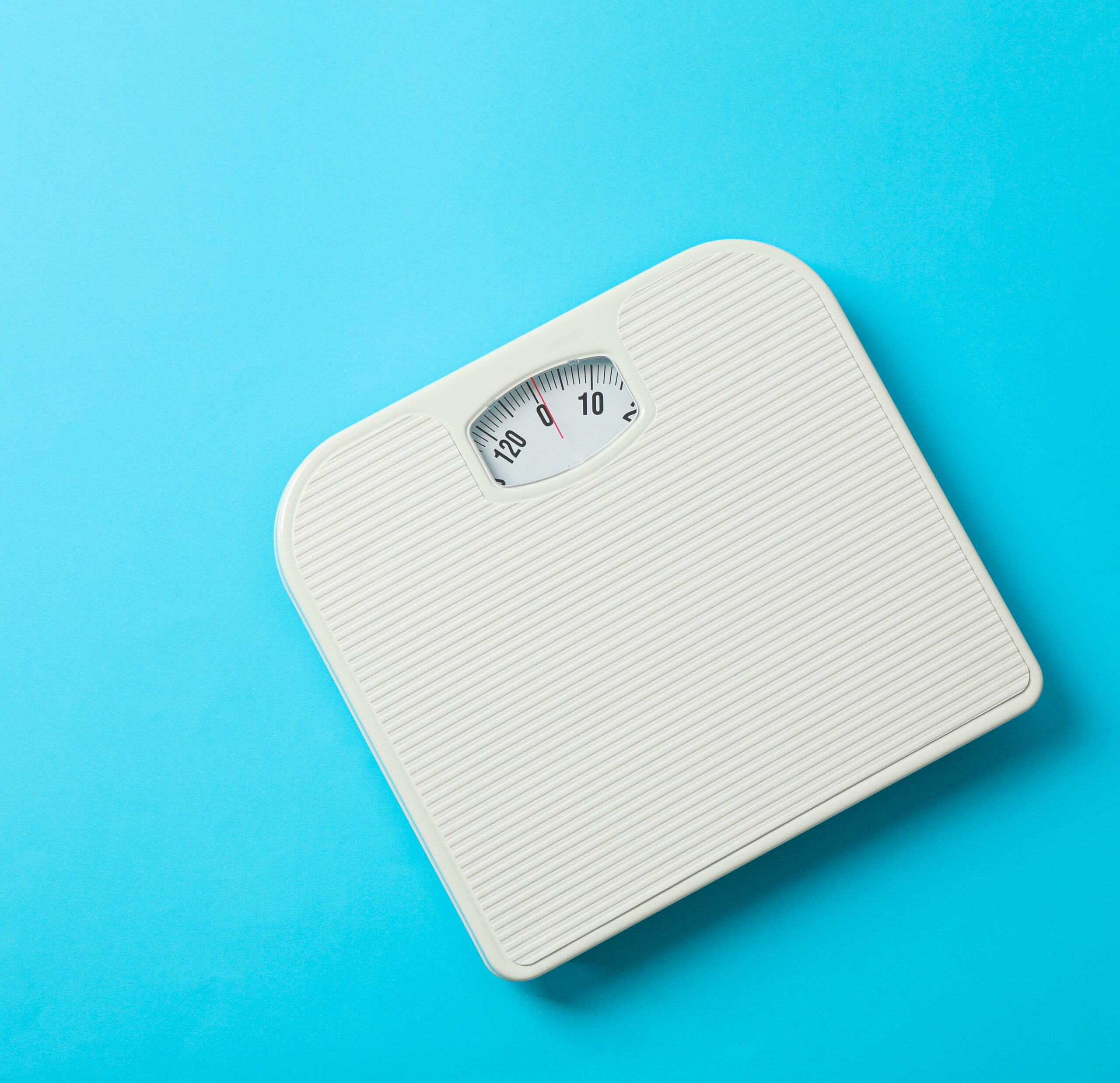 body weight scale on a blue plain background